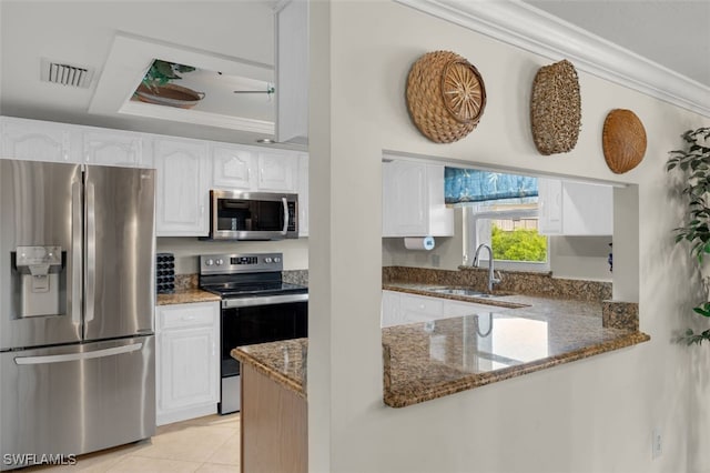 kitchen featuring dark stone countertops, sink, white cabinetry, and stainless steel appliances