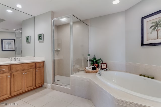 bathroom with vanity, tile patterned floors, and plus walk in shower