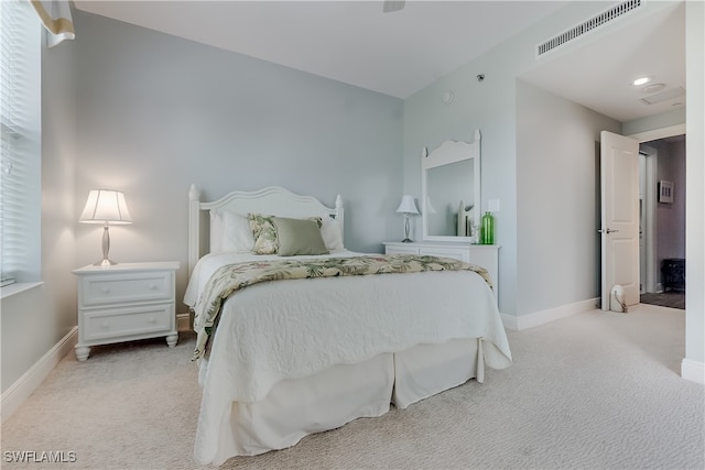 bedroom featuring light colored carpet