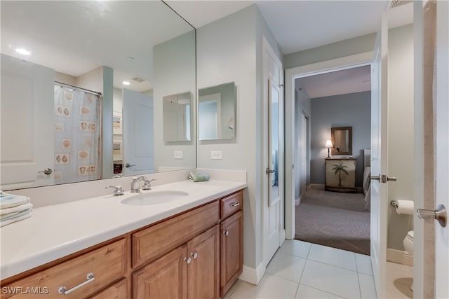 bathroom with vanity, toilet, and tile patterned floors