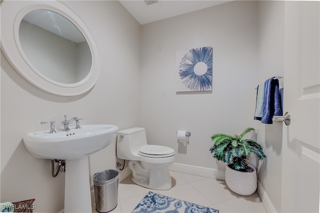 bathroom featuring toilet and tile patterned flooring