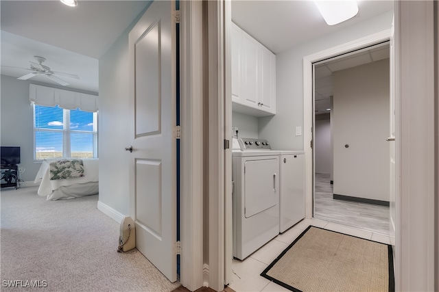 washroom with ceiling fan, light carpet, separate washer and dryer, and cabinets