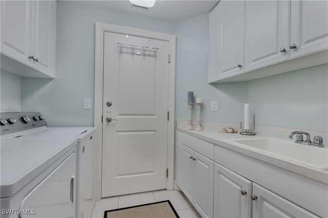 washroom with cabinets, sink, separate washer and dryer, and light tile patterned floors