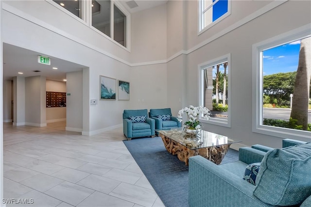 living room featuring a towering ceiling and light tile patterned flooring