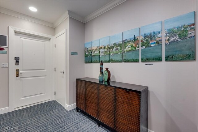 entryway with crown molding and dark colored carpet