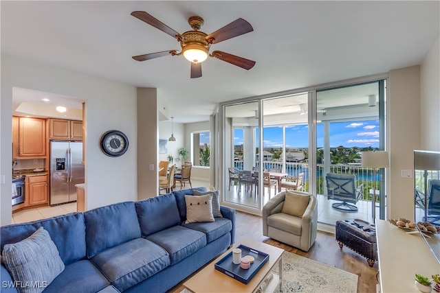 living room featuring light hardwood / wood-style floors and ceiling fan