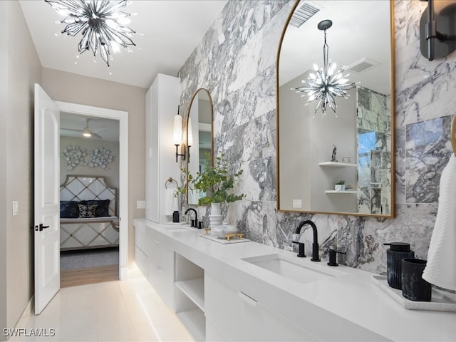 bathroom with vanity, tile patterned floors, and a notable chandelier