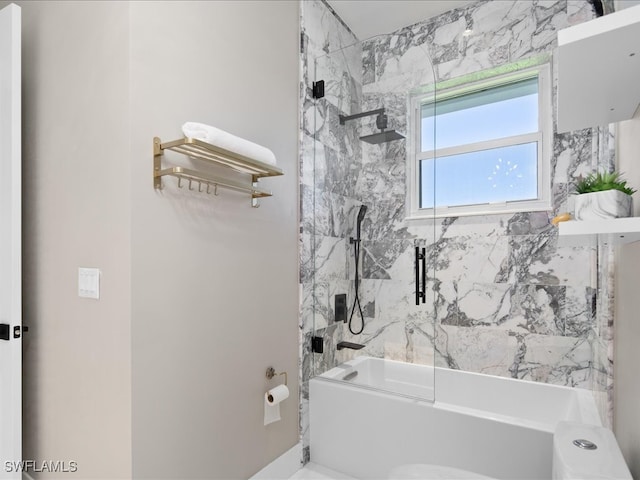 bathroom with tiled shower / bath combo and toilet