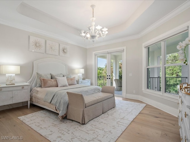 bedroom with a raised ceiling, light hardwood / wood-style floors, ornamental molding, a chandelier, and access to exterior