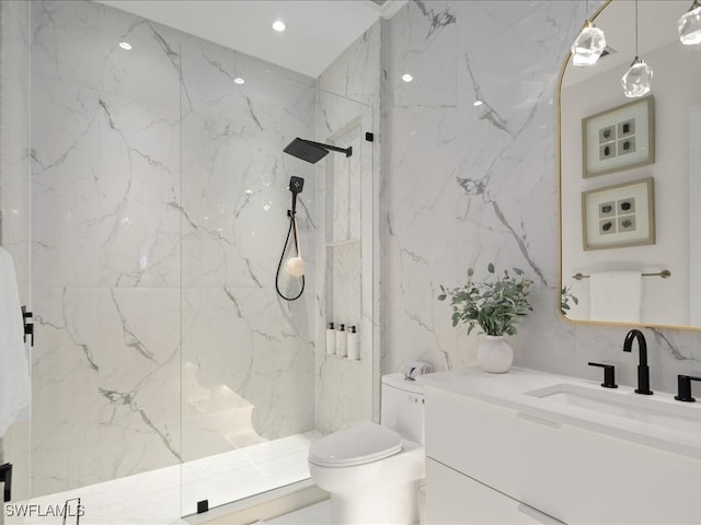 bathroom featuring a tile shower, tile walls, vanity, and toilet