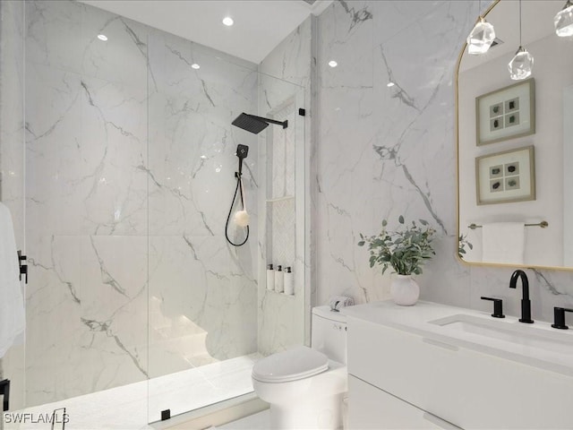 bathroom with toilet, vanity, a marble finish shower, stone wall, and tile walls