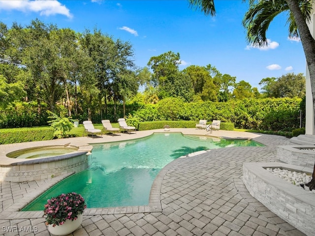 view of pool featuring a patio and an in ground hot tub