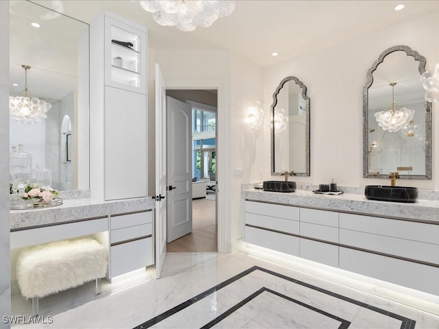 bathroom featuring marble finish floor, double vanity, a notable chandelier, and recessed lighting