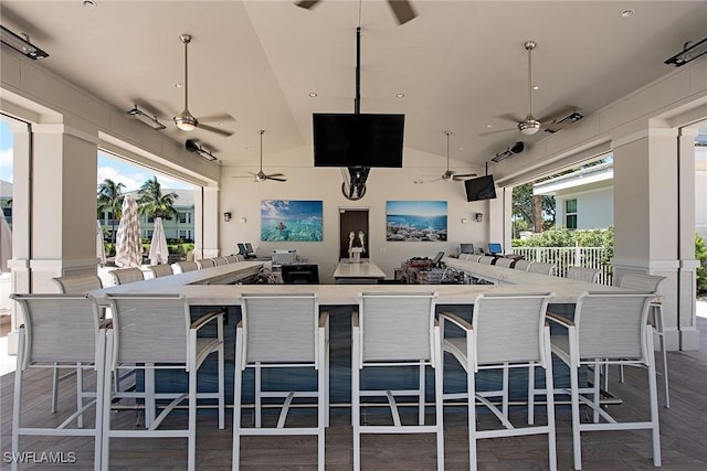 view of patio with ceiling fan and exterior bar