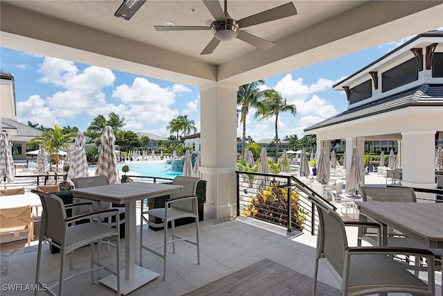 view of patio / terrace with ceiling fan and a community pool