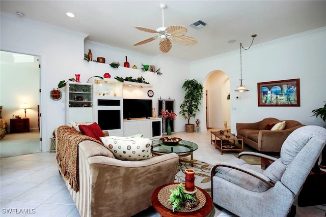 tiled living room with ornamental molding and ceiling fan