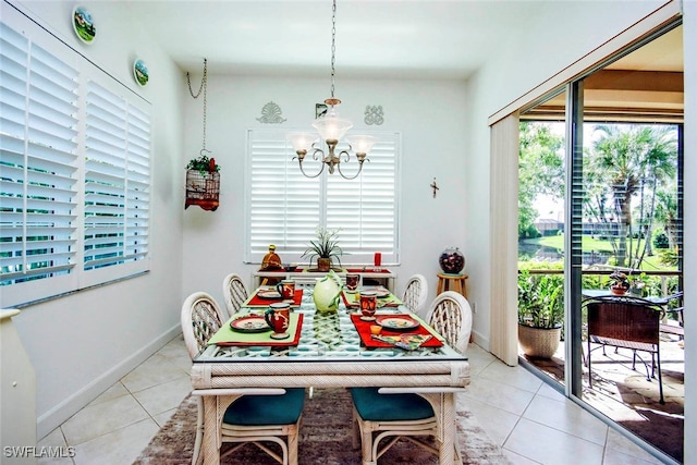 dining room featuring light tile patterned floors and a notable chandelier