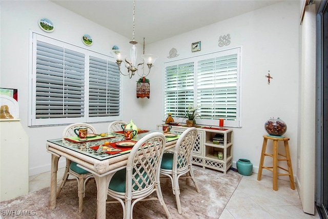 tiled dining room featuring a notable chandelier