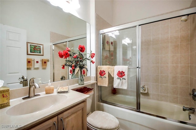 full bathroom with shower / bath combination with glass door, vanity, and toilet