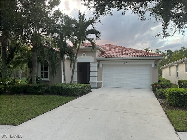 view of front facade featuring a front yard and a garage