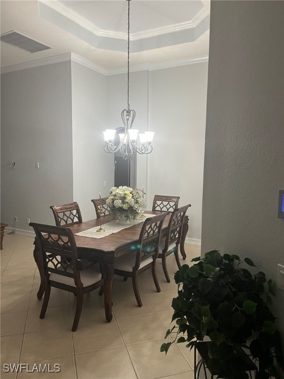 dining space with light tile patterned flooring, a chandelier, and ornamental molding