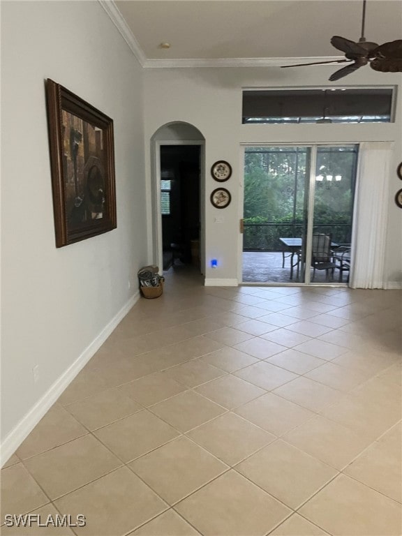 spare room featuring ceiling fan, light tile patterned flooring, and crown molding