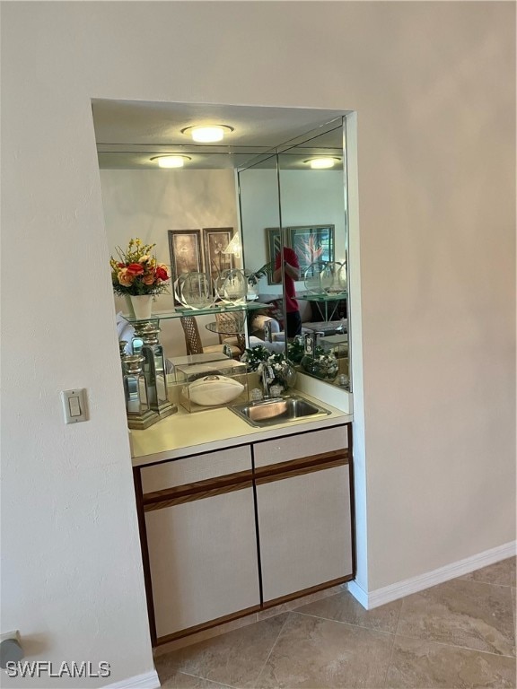 interior space with sink and light tile patterned flooring