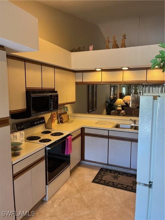 kitchen with white appliances, a sink, light countertops, a high ceiling, and light tile patterned flooring