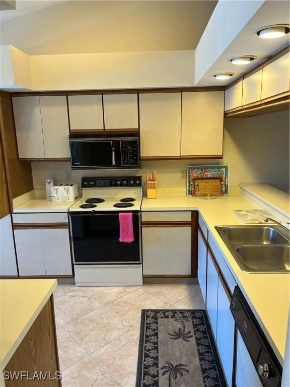 kitchen with black microwave, electric range, dishwasher, a sink, and light countertops