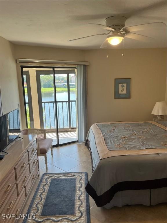 bedroom with access to exterior, light tile patterned flooring, ceiling fan, and a water view