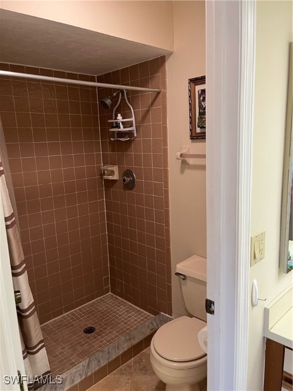 bathroom with toilet, a shower with curtain, and tile patterned floors