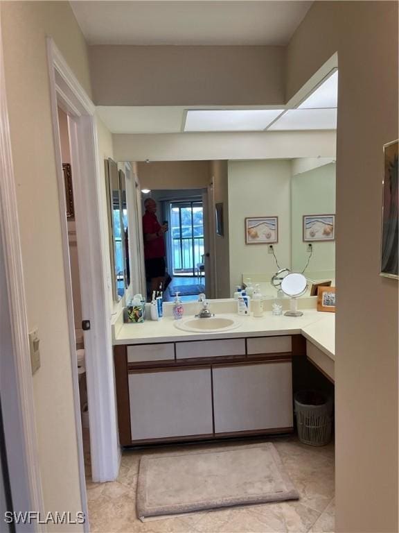 bathroom featuring vanity, tile patterned floors, and toilet