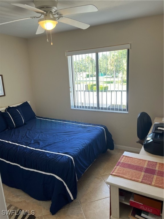 tiled bedroom featuring ceiling fan