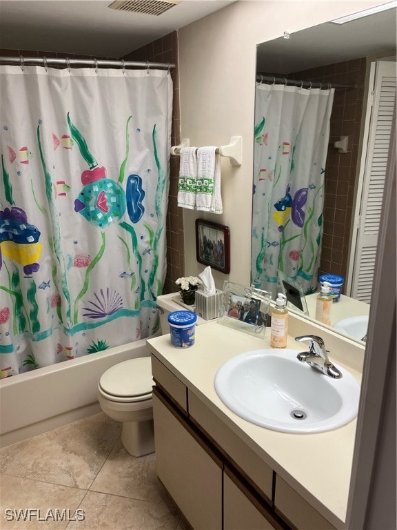 full bathroom featuring toilet, vanity, shower / bath combination with curtain, and tile patterned floors