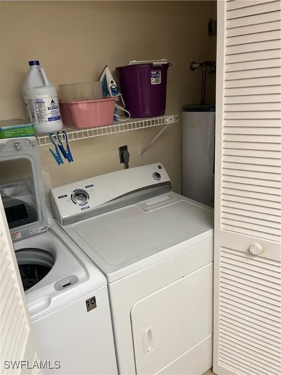 clothes washing area with independent washer and dryer and water heater