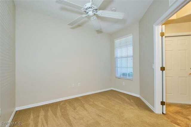 unfurnished room with ceiling fan and light colored carpet