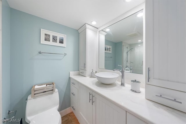 bathroom with vanity, toilet, and an enclosed shower