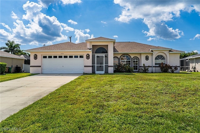 view of front of property with a garage and a front lawn