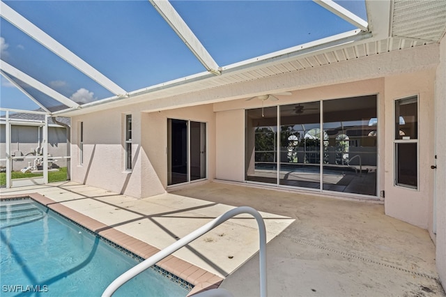 view of pool featuring glass enclosure and a patio area