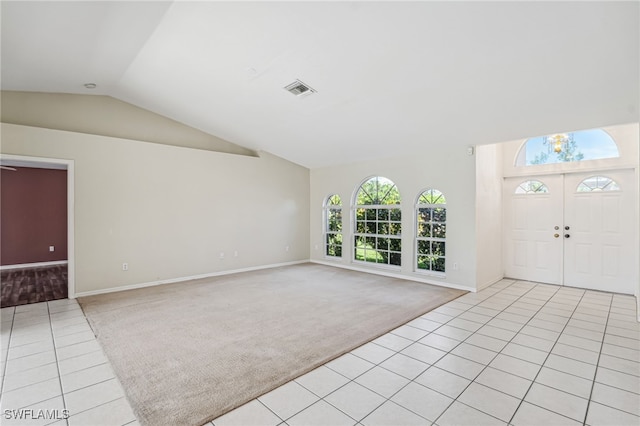 carpeted entryway featuring vaulted ceiling