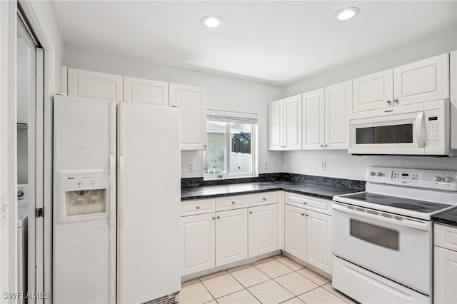 kitchen with white cabinets, white appliances, and light tile patterned flooring