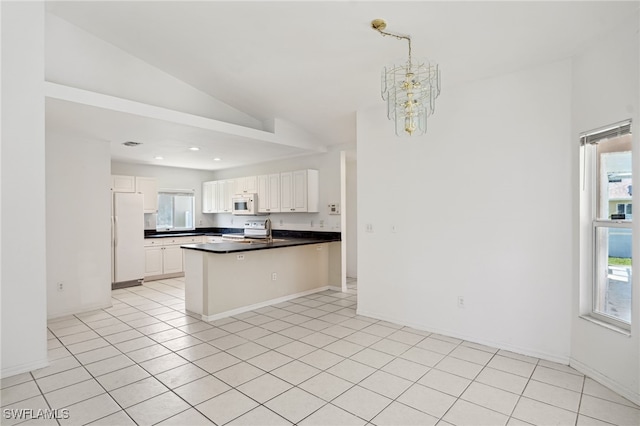 kitchen with kitchen peninsula, white appliances, white cabinetry, a notable chandelier, and vaulted ceiling