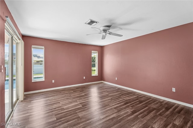 spare room featuring ceiling fan and dark hardwood / wood-style flooring