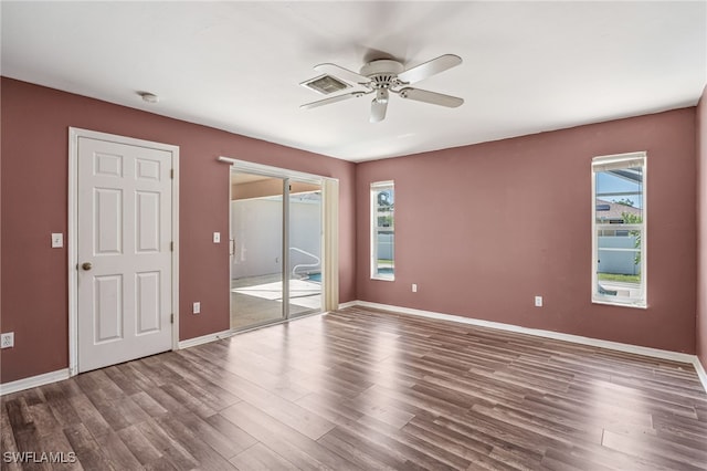 unfurnished bedroom featuring access to outside, hardwood / wood-style flooring, and ceiling fan