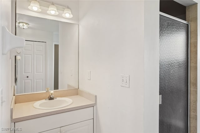 bathroom featuring walk in shower and vanity