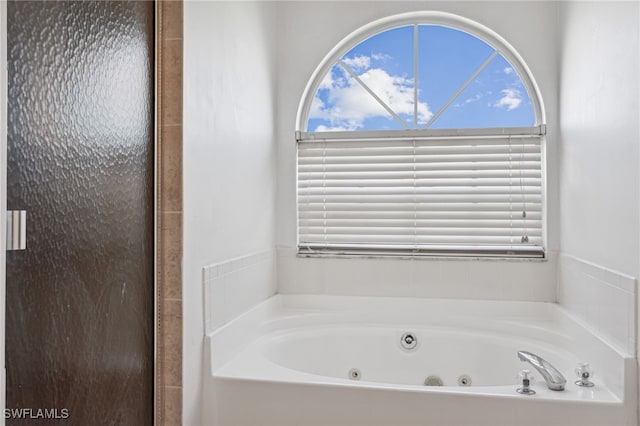 bathroom with a tub to relax in