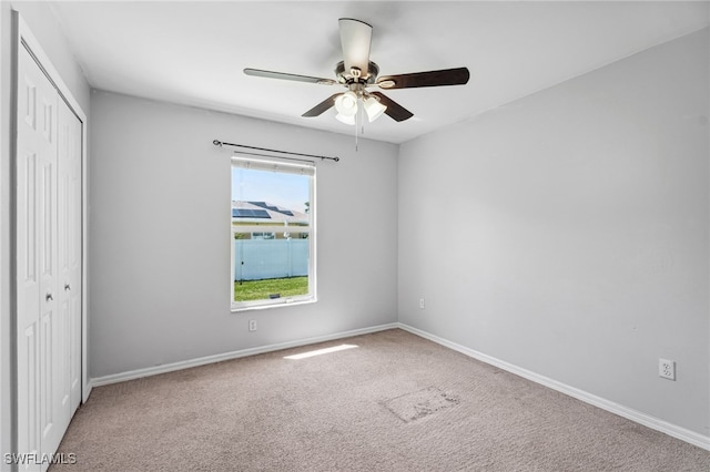 unfurnished bedroom featuring a closet, ceiling fan, and carpet flooring