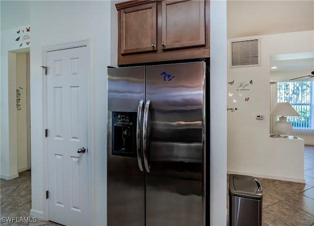 kitchen featuring stainless steel fridge and light tile patterned floors