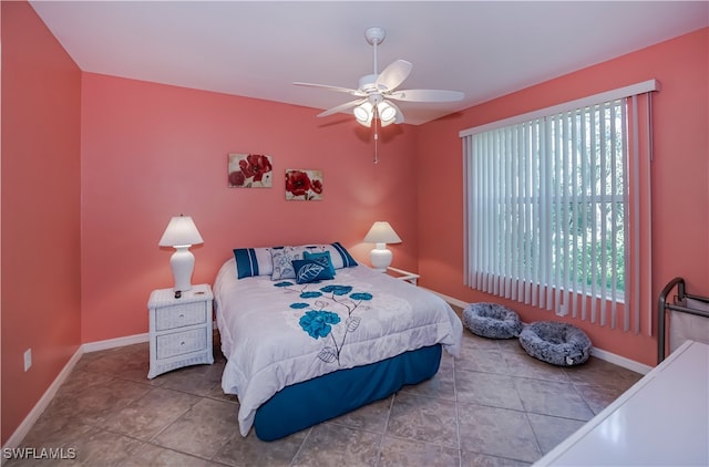 bedroom featuring ceiling fan, multiple windows, and tile patterned flooring