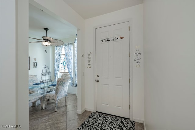 entryway featuring ceiling fan and light tile patterned floors